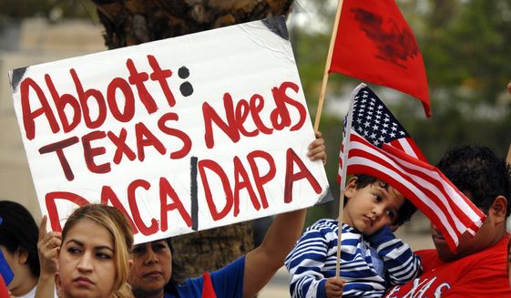 Over 100 hundred people demonstrated in front of the Federal Courthouse in Brownsville, Texas, Thursday, March 19, 2015. The Justice Department might face sanctions if a federal judge determines its attorneys misled him about whether part of President Barack Obama's executive action on immigration was implemented prior to it being put on hold by the judge. U.S. District Judge Andrew Hanen last month halted Obama's plan. The president's plan would spare from deportation up to 5 million people in the U.S. illegally. (AP Photo/Brownsville Herald, Brad Doherty)