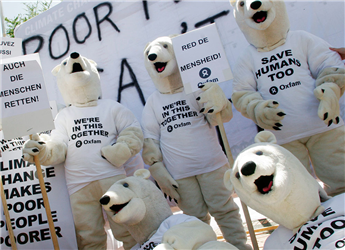Environmental activists dressed as polar bears demonstrate outside the United Nations Climate Conference in Nusa Dua, Bali, Indonesia, on Dec. 14,...